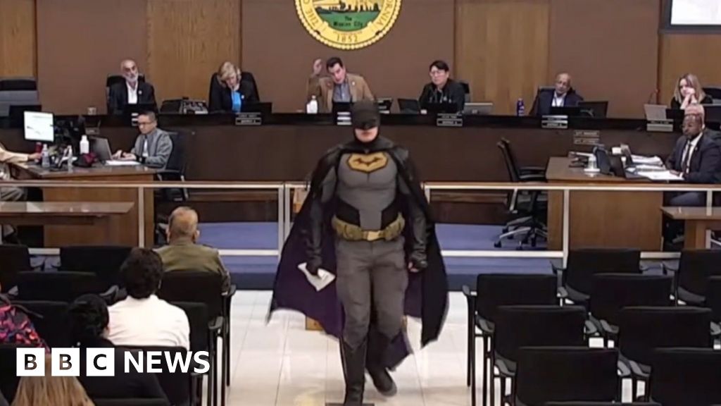 Activist Dressed as Batman Confronts Council Over ICE Presence at Super Bowl